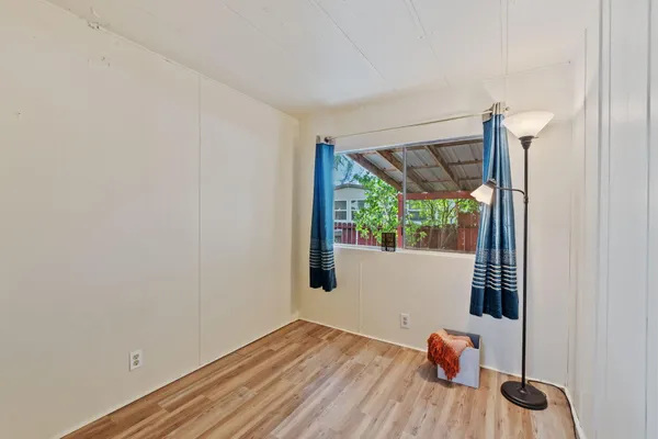a view of a room with wooden floor and windows
