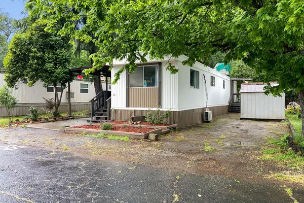 a backyard of a house with table and chairs