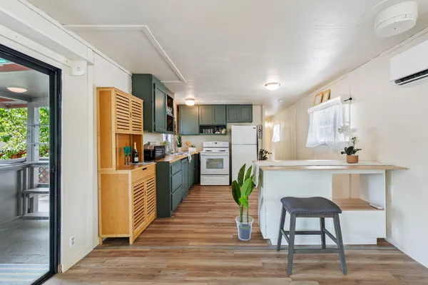 a kitchen with refrigerator and chairs