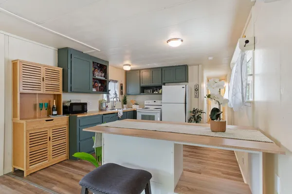 a kitchen with stainless steel appliances a stove refrigerator sink and microwave