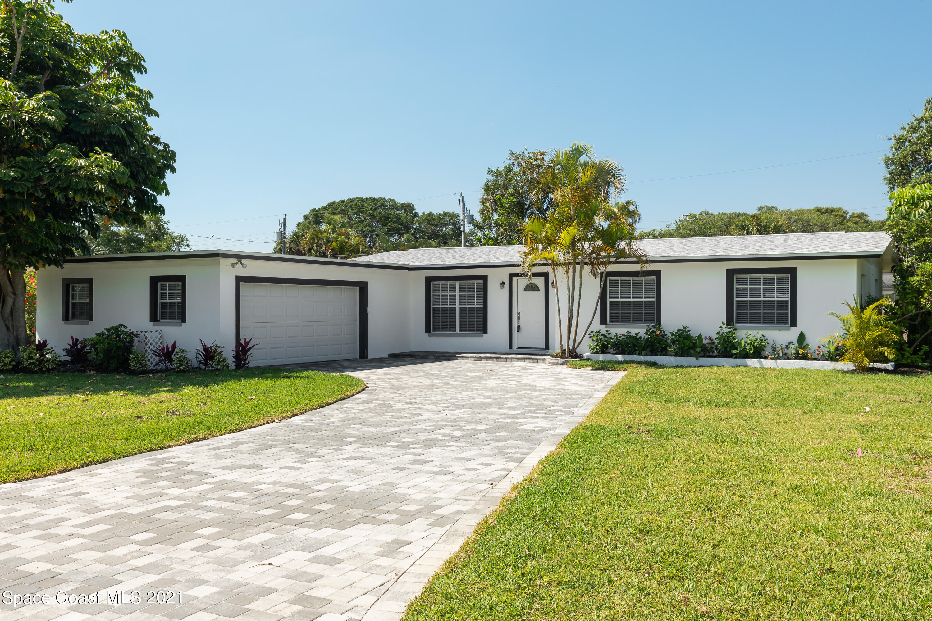 640 Java Road Cocoa Beach, FL 32931 - Photo 1 of 18 a front view of house with yard and green space