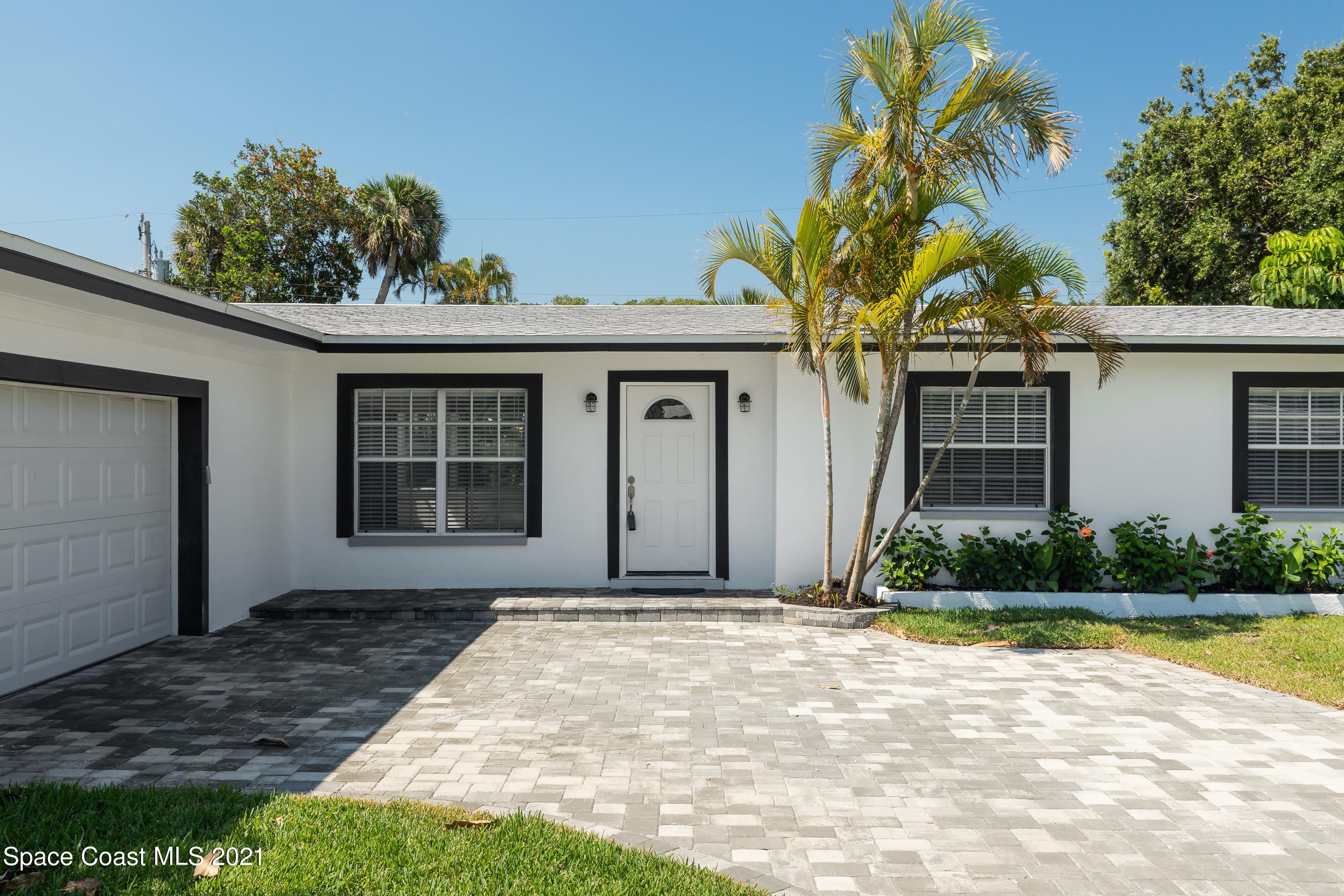 640 Java Road Cocoa Beach, FL 32931 - Photo 2 of 18 a front view of a house with garden