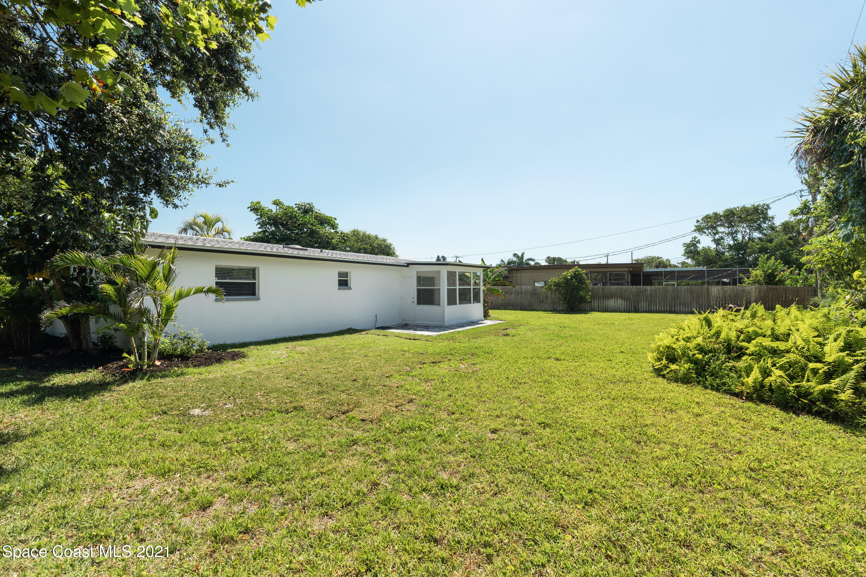 640 Java Road Cocoa Beach, FL 32931 - Photo 16 of 18 a view of a house with backyard and garden