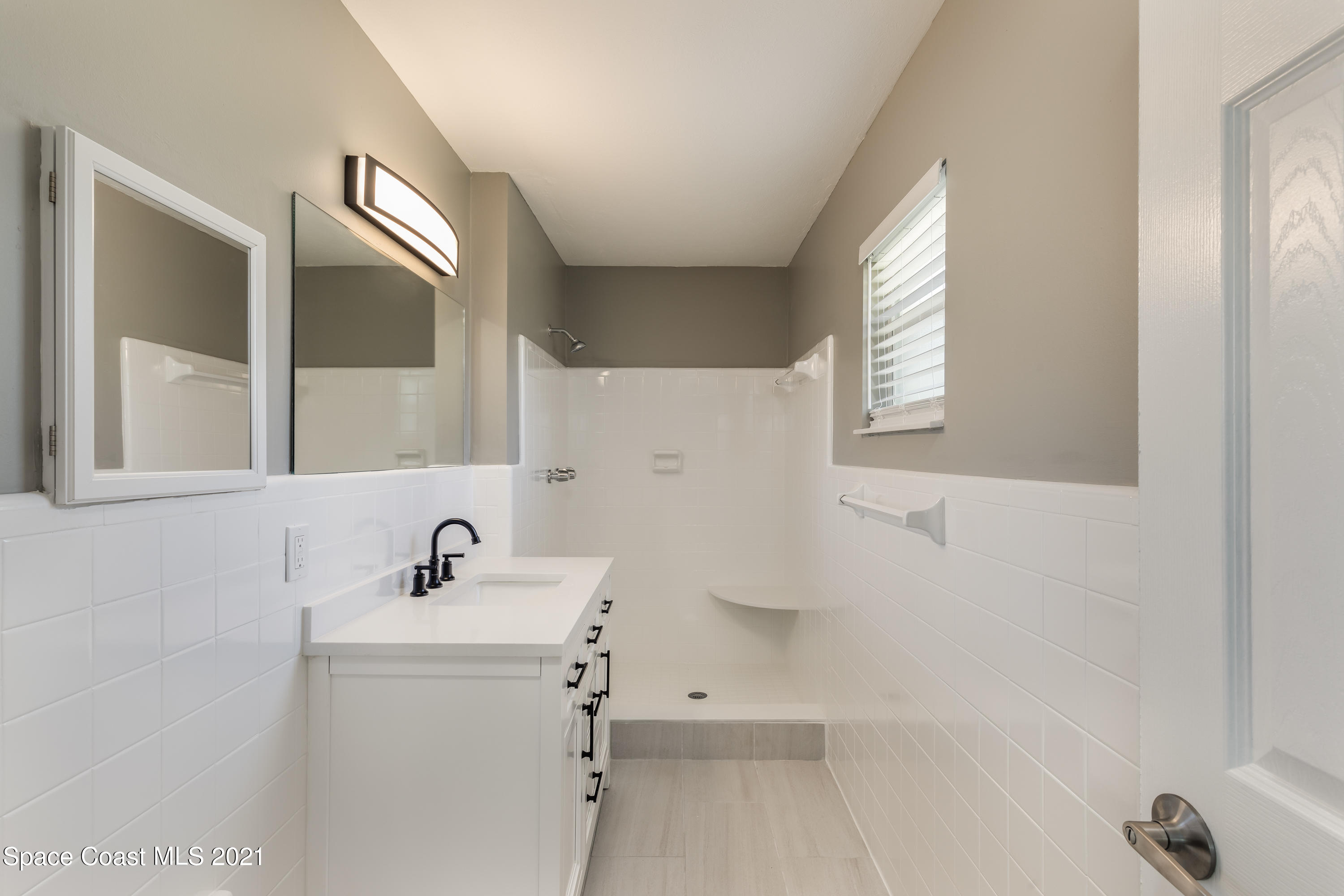 640 Java Road Cocoa Beach, FL 32931 - Photo 6 of 18 a bathroom with a sink a toilet and a mirror