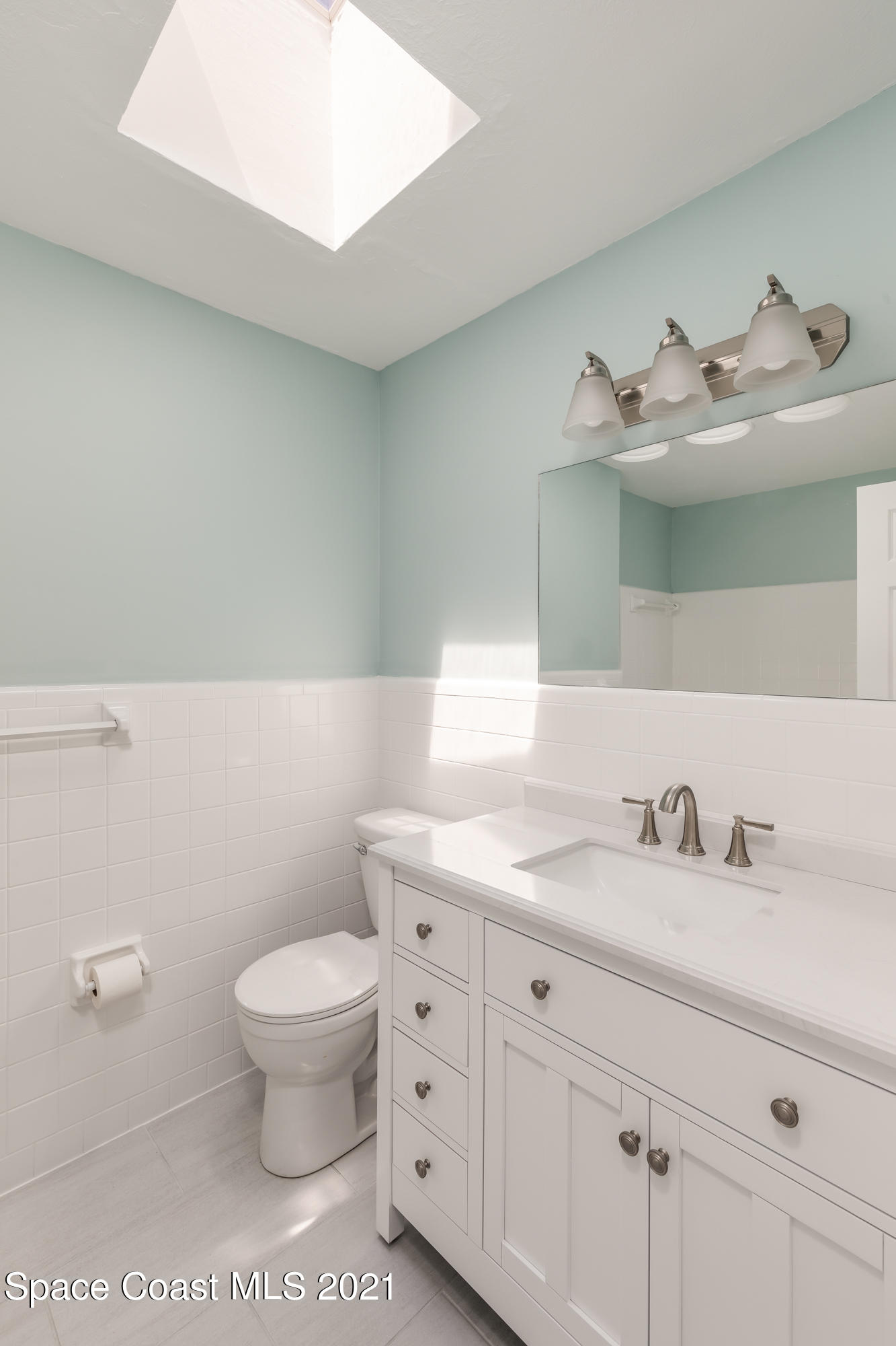640 Java Road Cocoa Beach, FL 32931 - Photo 8 of 18 a bathroom with a granite countertop toilet sink and mirror