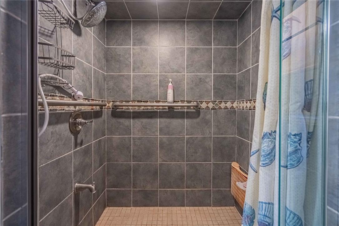 579 Cherry Road Northampton, PA 18067 - Photo 31 of 57 Step into a fully tiled handicap accessible shower with convenient grab bars and a sleek, modern design.