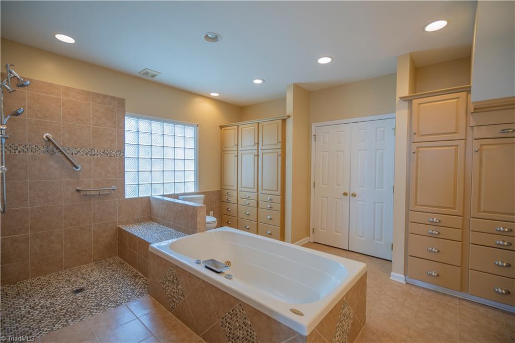 2307 Riverside Drive Lexington, NC 27292 - Photo 21 of 30 Primary bath with walk-in tile shower, jet tub, built-ins, walk-in closet