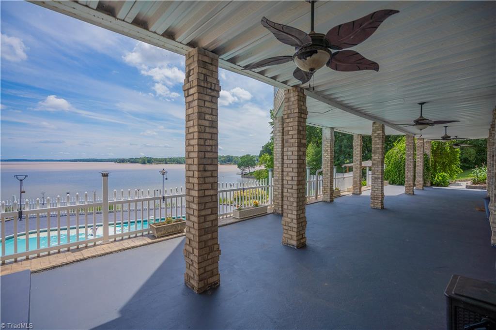 Covered patio lakeside overlooking inground pool (63'x18')