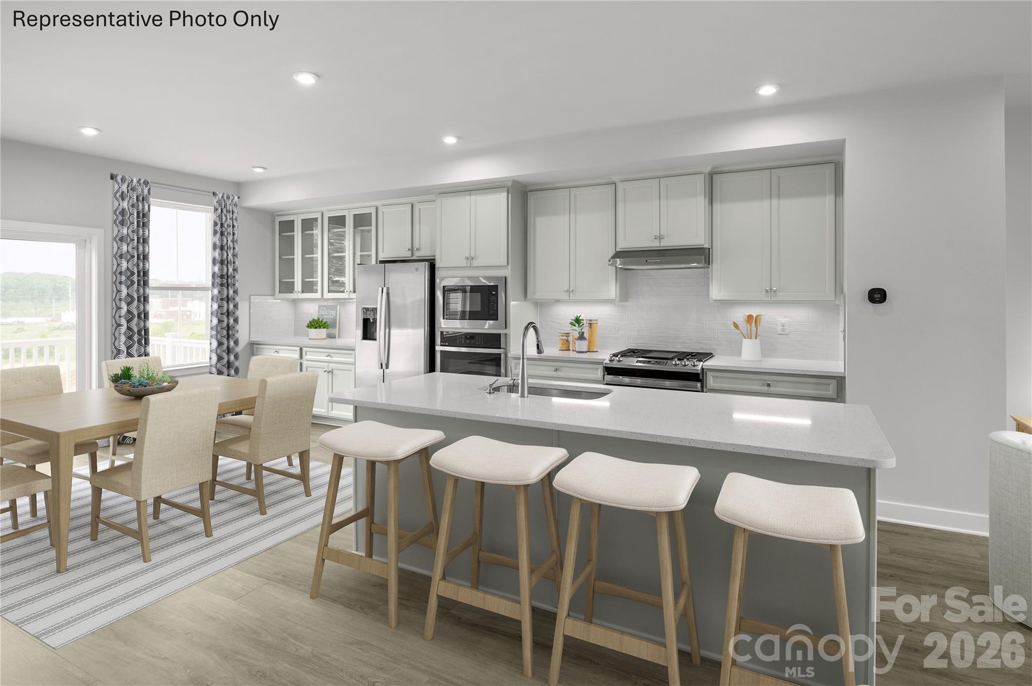 1024 Bracken Hill Road Indian Trail, NC 28079 - Photo 3 of 11 a kitchen with stainless steel appliances granite countertop a table and chairs