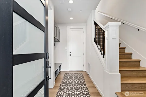 a view of entryway with stairs and wooden floor