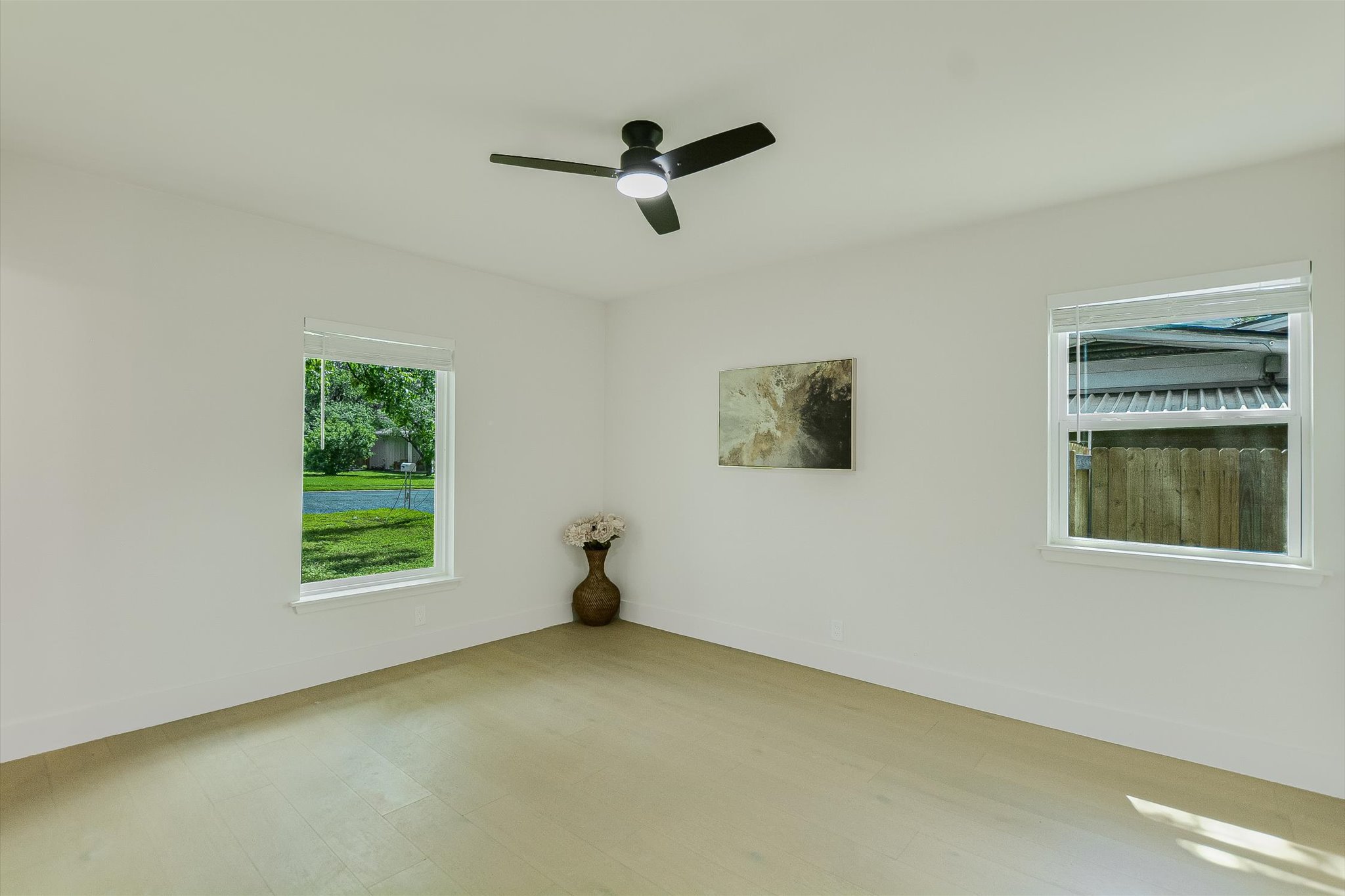 4505 Kitty Avenue Austin, TX 78721 - Photo 6 of 11 A well-lit bedroom features pristine walls and natural light, offering serene views of the outdoors.