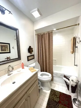 a bathroom with a sink toilet a mirror and shower