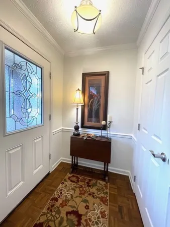 a living room with a baby crib furniture and a window