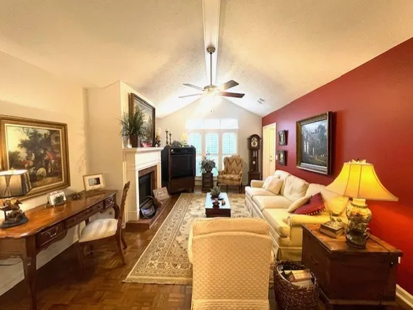 a living room with furniture a chandelier and a flat screen tv