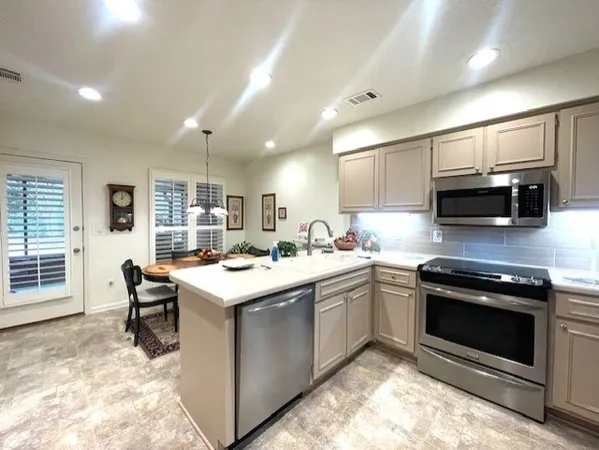 a kitchen with a stove sink and microwave