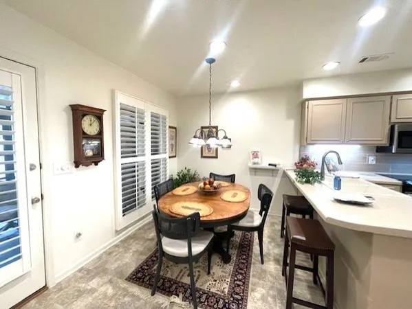 a dining room with furniture and window