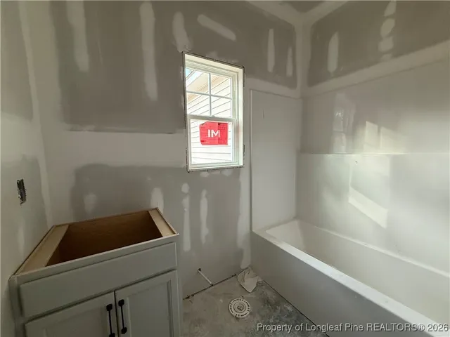 a bathroom with a bathtub sink and window