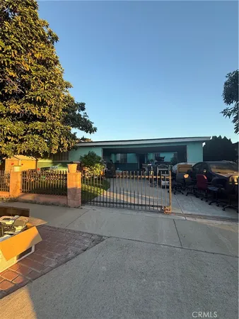 a view of a patio with a table and chairs with wooden fence