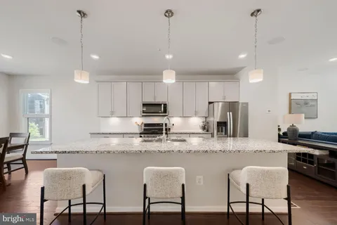 a utility room with cabinets and wooden floor