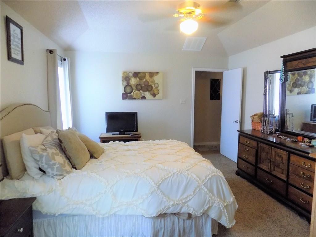 2306 Raintree Path Round Rock, TX 78664 - Photo 9 of 15 Vaulted ceiling bedroom featuring carpet flooring, a ceiling fan with integrated lighting, and a white paneled door