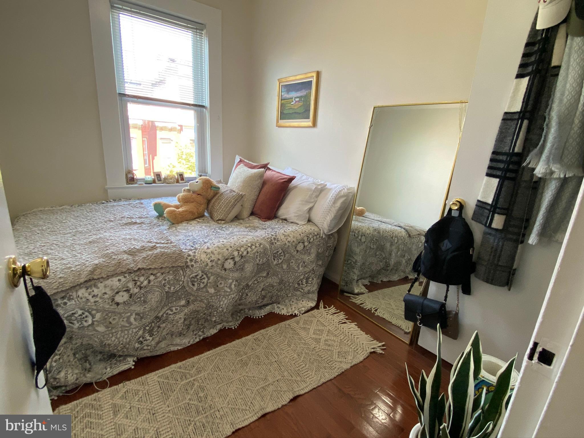 1456 Corcoran Street Northwest, Unit 3 Washington, DC 20009 - Photo 14 of 26 a bedroom with a bed and wooden floor
