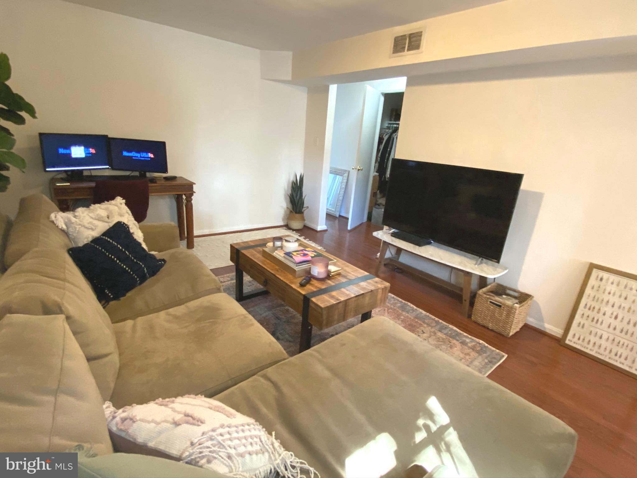 1456 Corcoran Street Northwest, Unit 3 Washington, DC 20009 - Photo 2 of 26 a living room with furniture and a flat screen tv