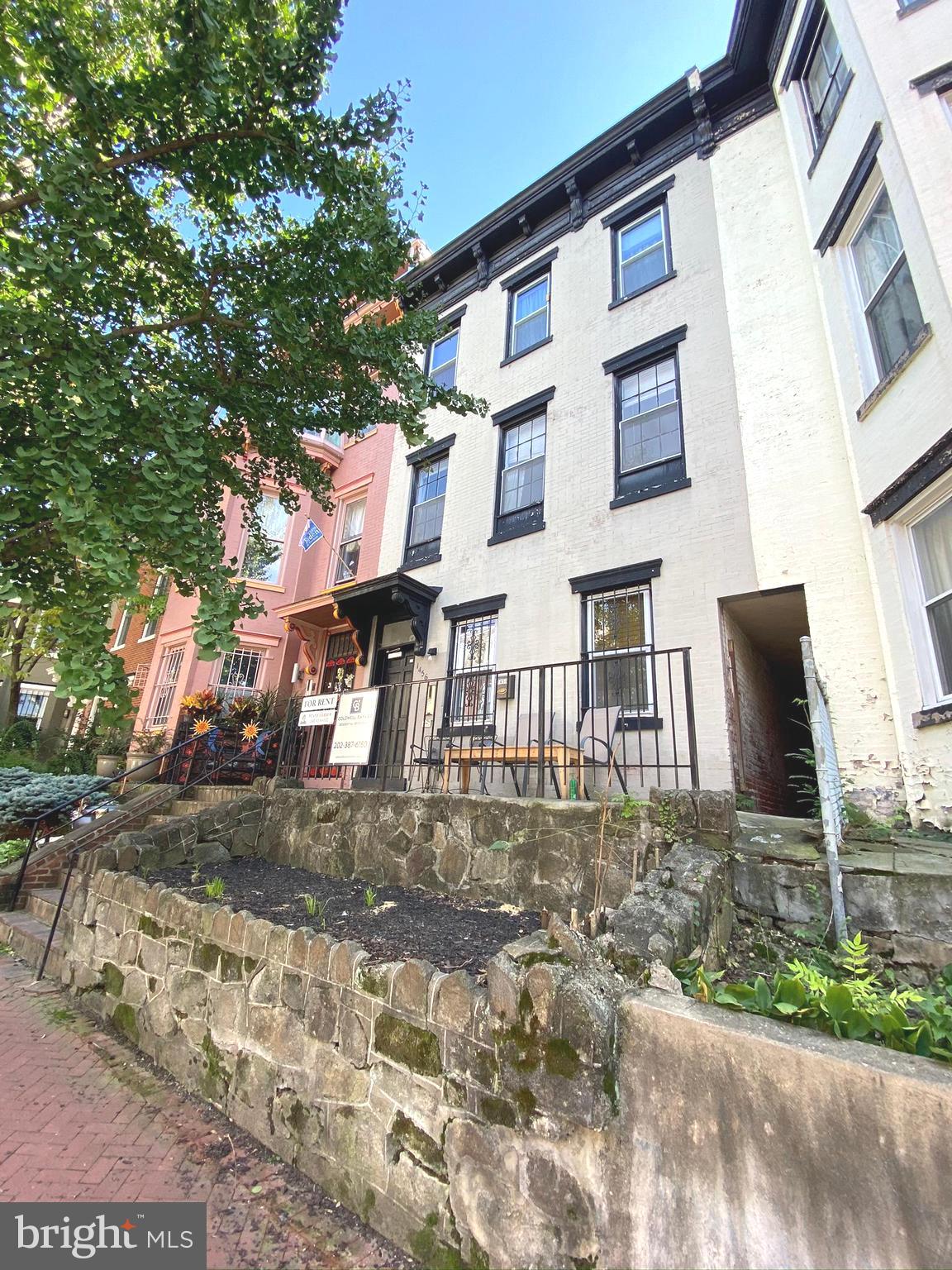 1456 Corcoran Street Northwest, Unit 3 Washington, DC 20009 - Photo 22 of 26 a front view of a house with a yard