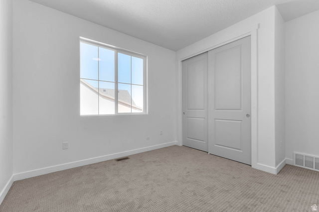 1024 South Tanner Road Santaquin, UT 84655 - Photo 6 of 20 Unfurnished bedroom with light carpet and a closet