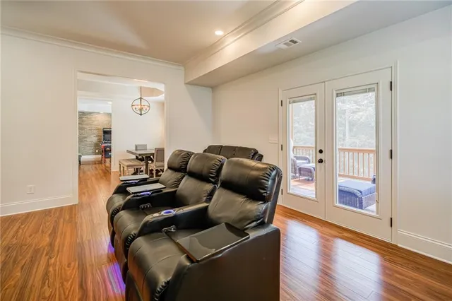 a balcony with wooden floor and outdoor seating