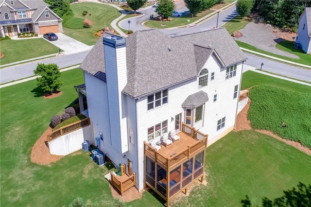 an aerial view of a house with swimming pool patio and outdoor seating