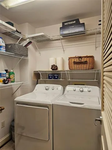 a view of storage and utility room with washer and dryer