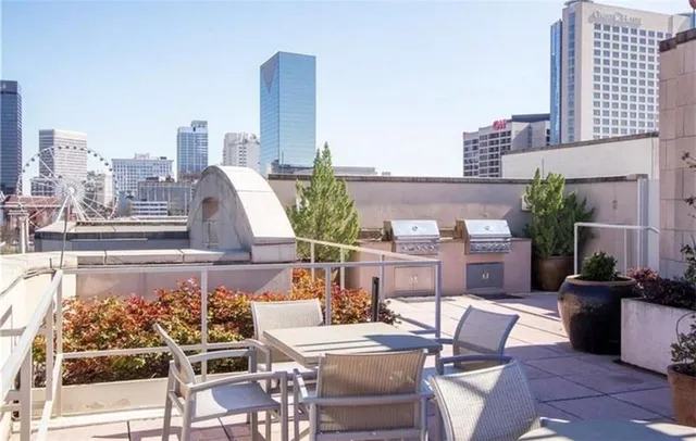 a bathroom with a granite countertop sink and a refrigerator