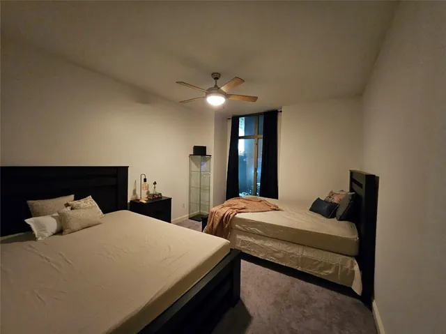a bathroom with a granite countertop toilet sink and mirror