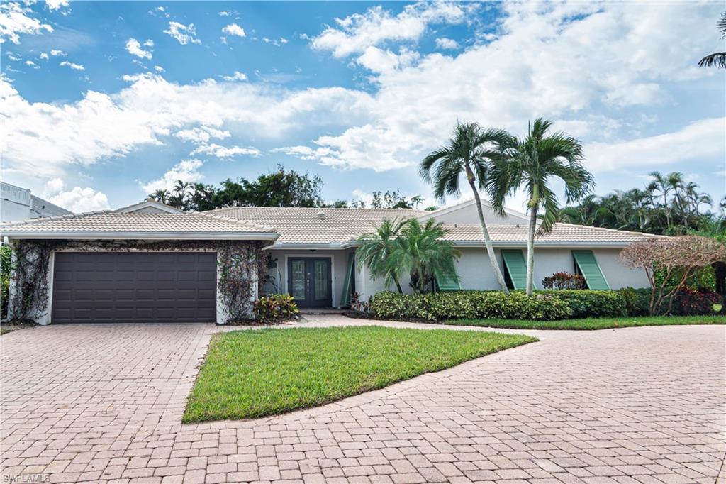 504 Turtle Hatch Road Naples, FL 34103 - Photo 2 of 5 a front view of house with yard and green space