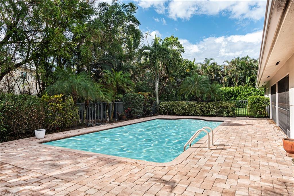504 Turtle Hatch Road Naples, FL 34103 - Photo 3 of 5 a view of a swimming pool with a yard