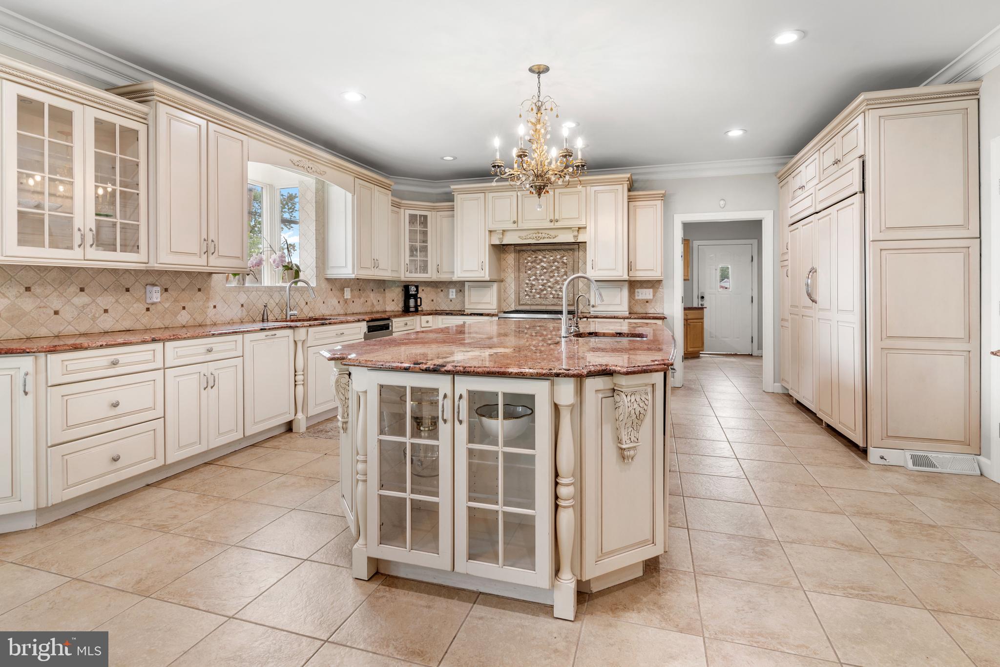 3213 Hatton Road Baltimore, MD 21208 - Photo 13 of 69 a kitchen with stainless steel appliances granite countertop a stove a sink and a refrigerator