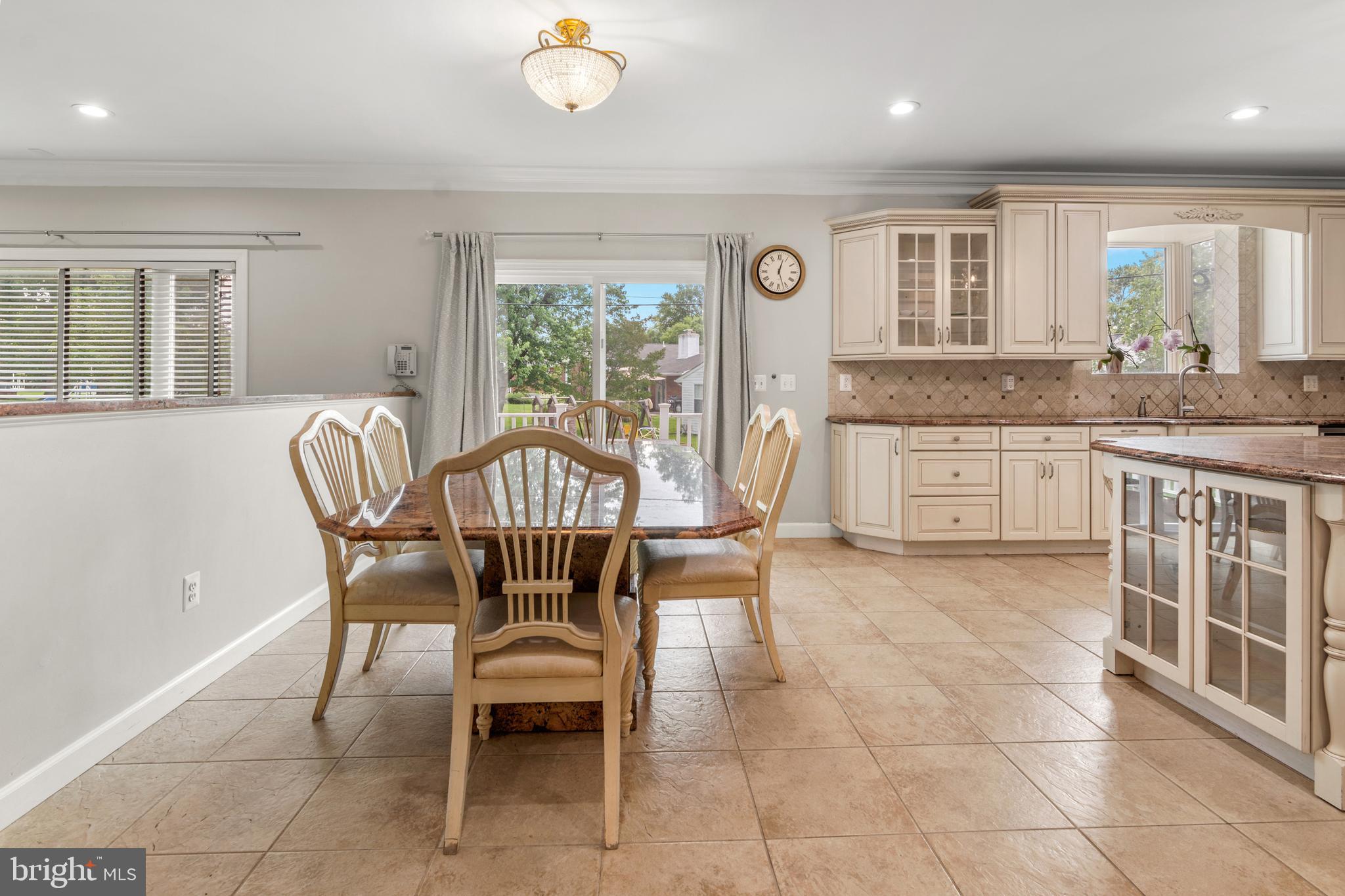 3213 Hatton Road Baltimore, MD 21208 - Photo 19 of 69 a view of a dining room with furniture and a floor to ceiling window