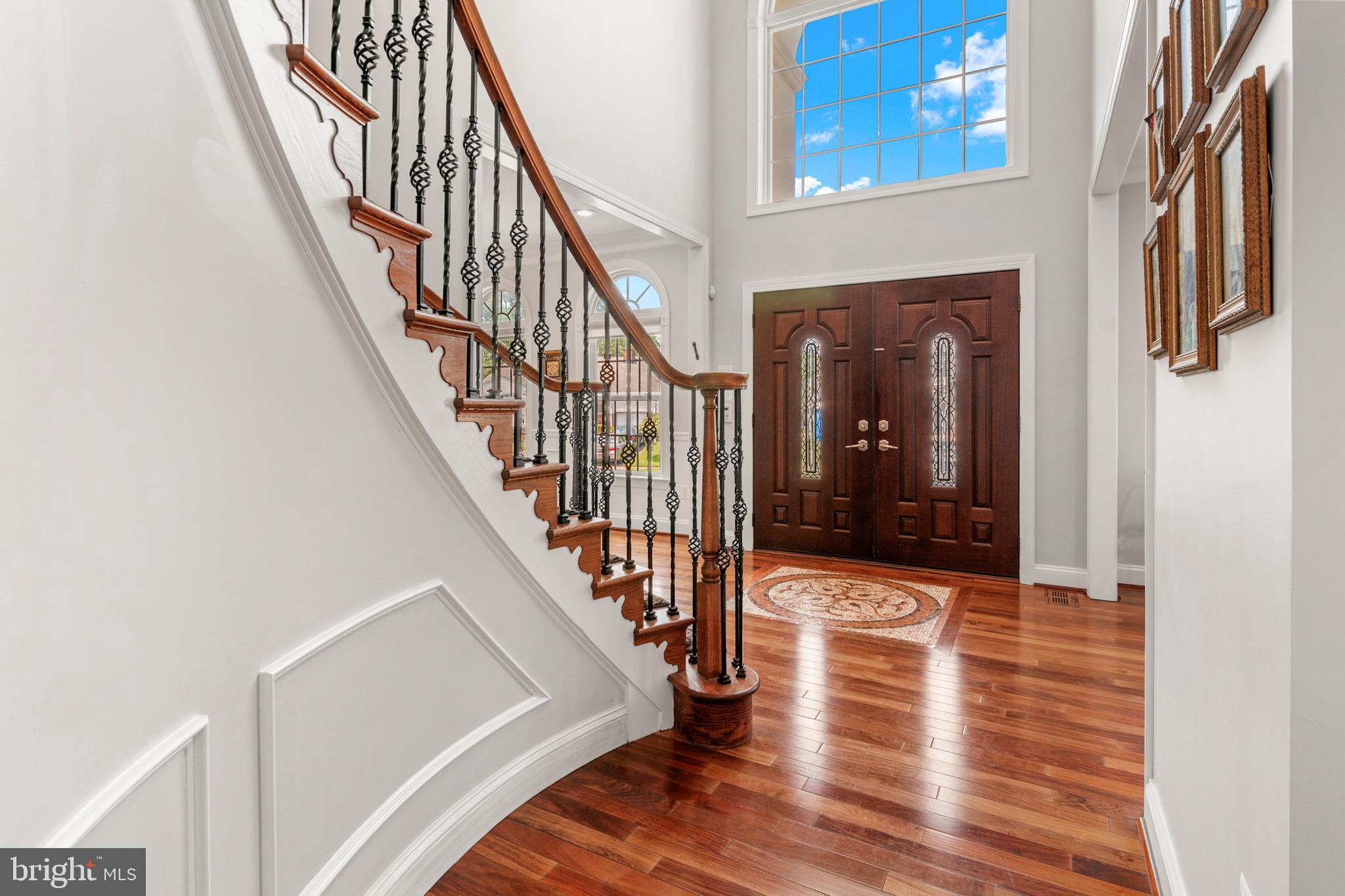 3213 Hatton Road Baltimore, MD 21208 - Photo 2 of 69 a view of staircase with wooden floor and a chandelier