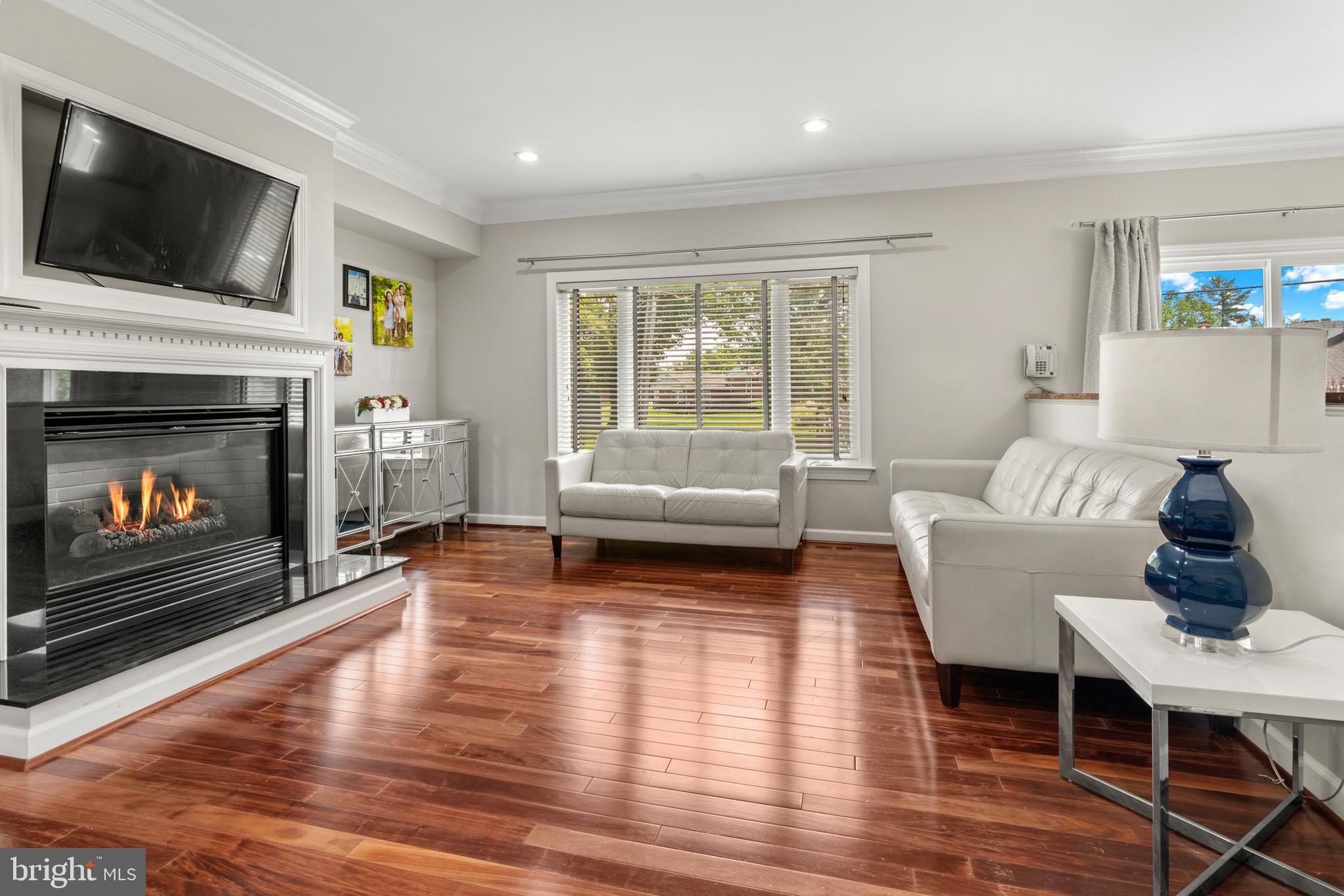 3213 Hatton Road Baltimore, MD 21208 - Photo 22 of 69 a living room with furniture a flat screen tv and a fireplace