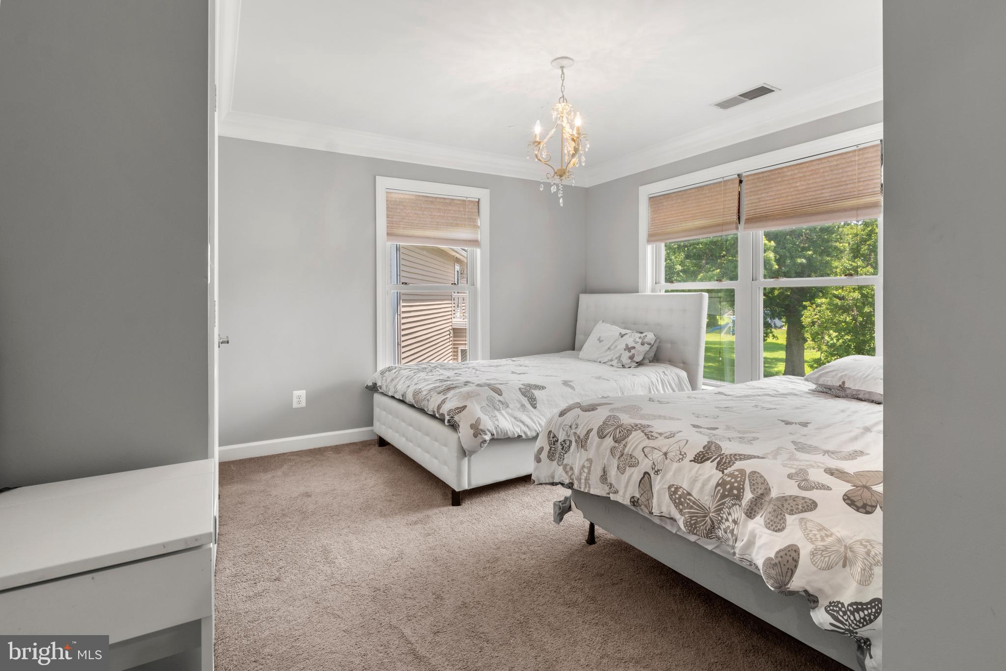 3213 Hatton Road Baltimore, MD 21208 - Photo 31 of 69 a bedroom with a bed chandelier and a window