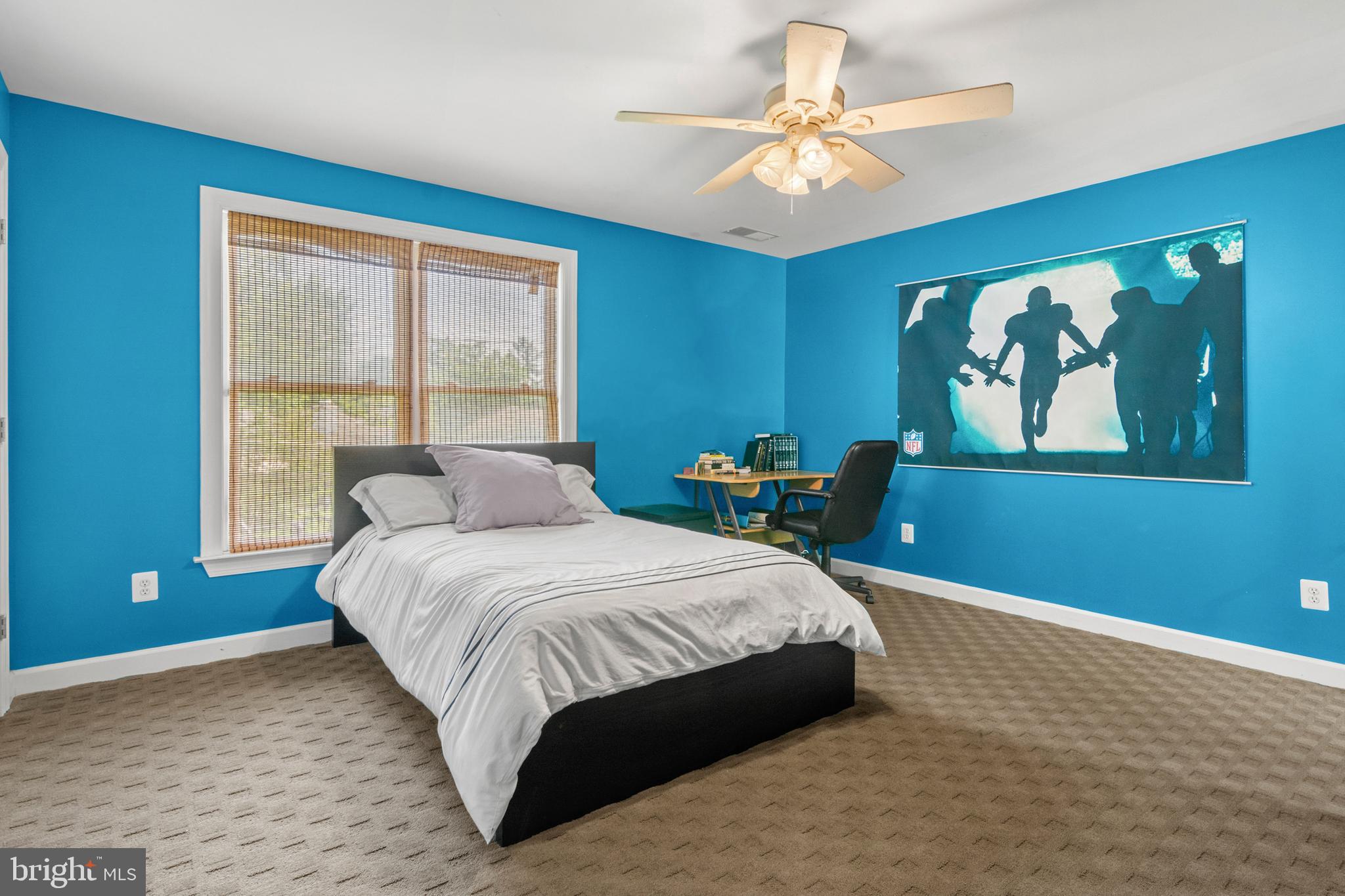 3213 Hatton Road Baltimore, MD 21208 - Photo 37 of 69 a bedroom with a large bed and a chandelier