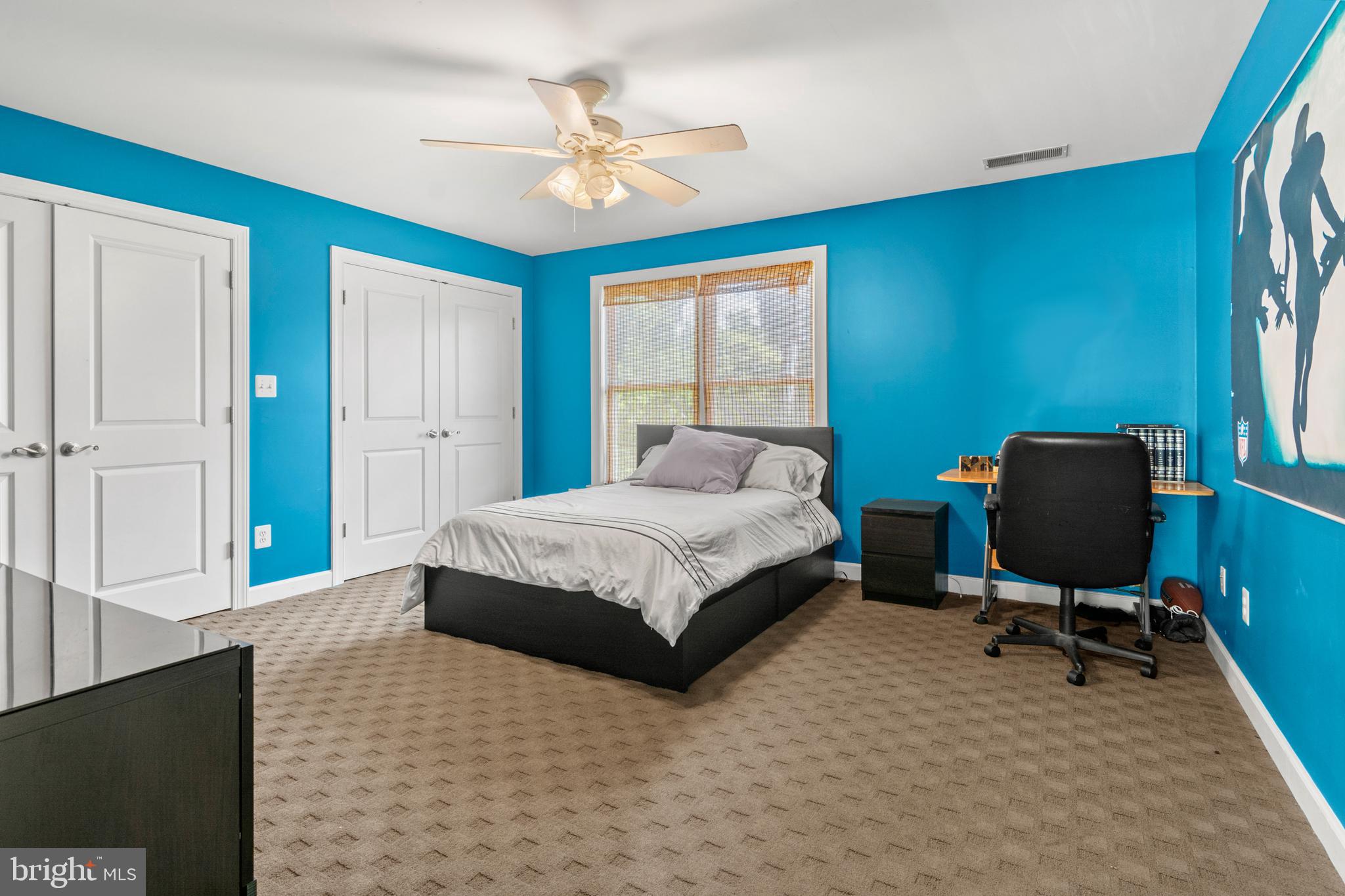 3213 Hatton Road Baltimore, MD 21208 - Photo 38 of 69 a bedroom with a bed cabinets and a window