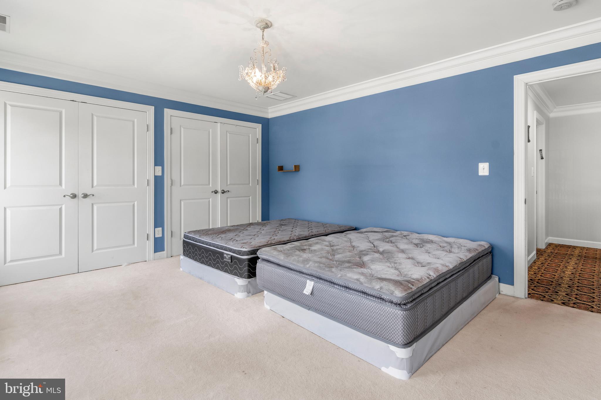 3213 Hatton Road Baltimore, MD 21208 - Photo 40 of 69 a spacious bedroom with a bed and cabinet