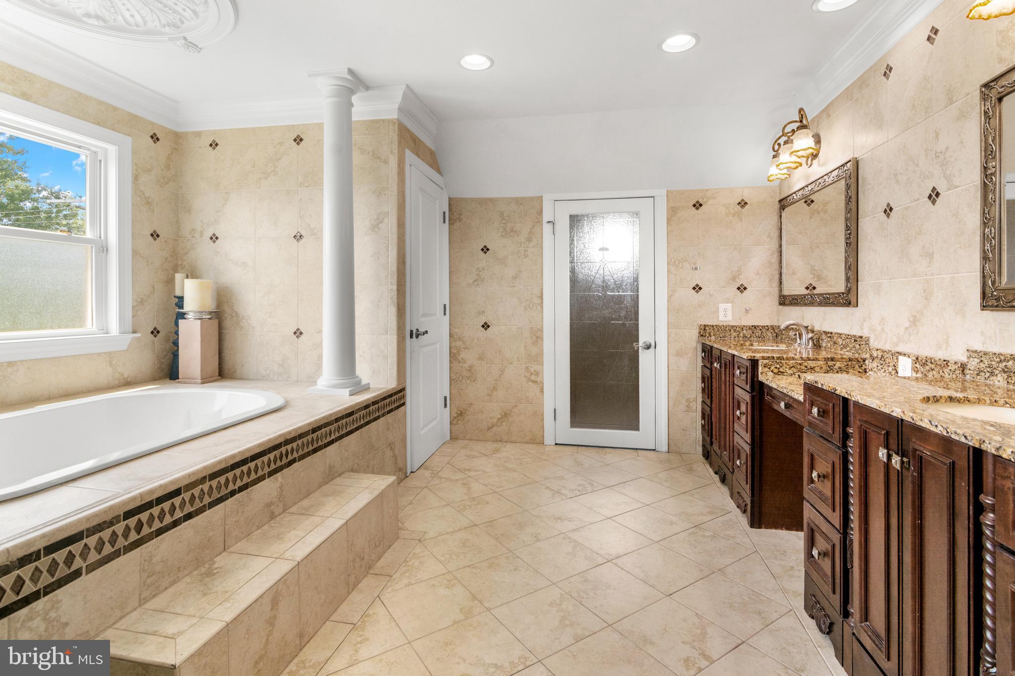 3213 Hatton Road Baltimore, MD 21208 - Photo 41 of 69 a large spacious bathroom with a granite countertop double vanity sink a mirror and a shower