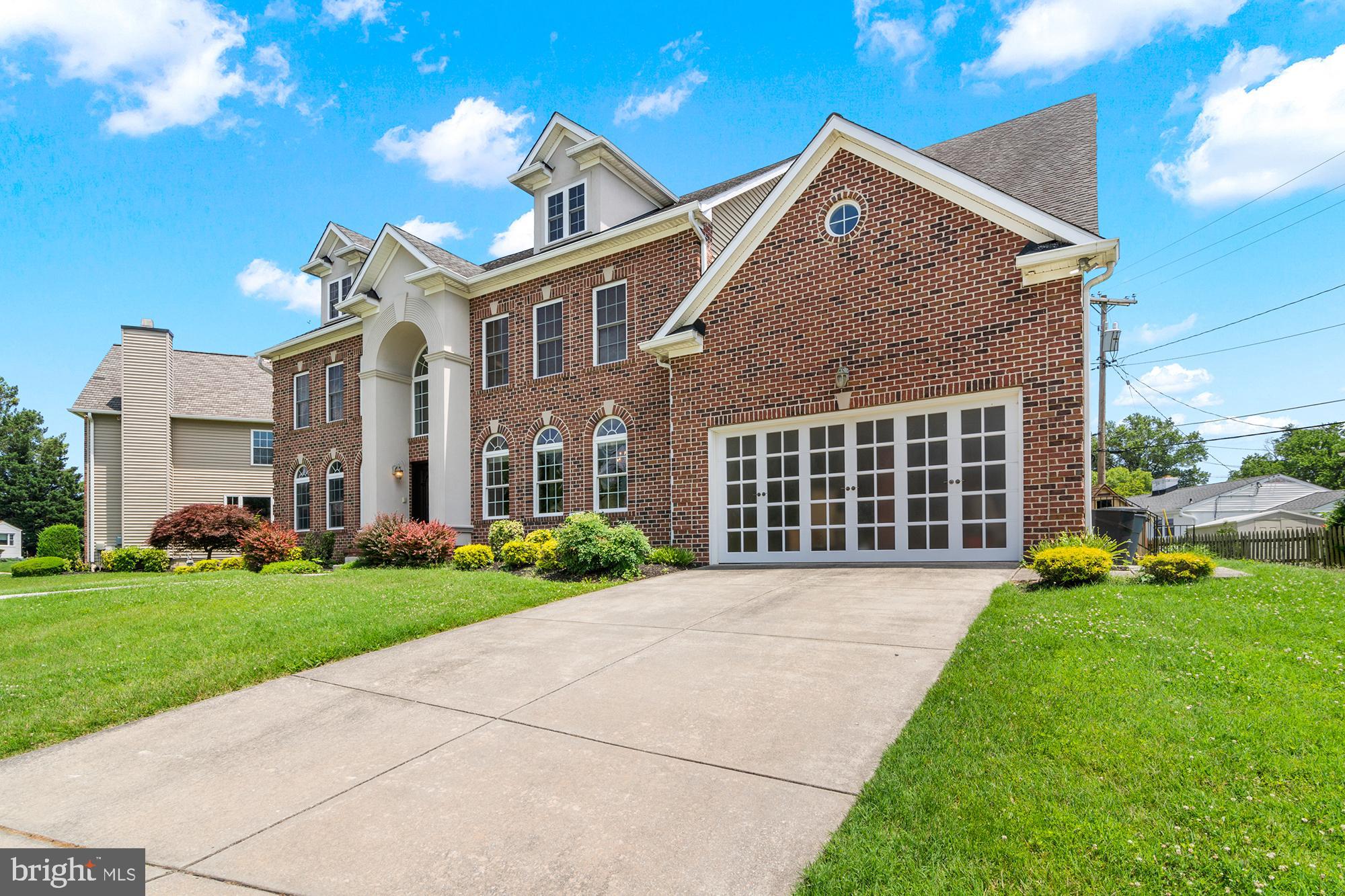 3213 Hatton Road Baltimore, MD 21208 - Photo 56 of 69 a front view of a house with a yard and garage