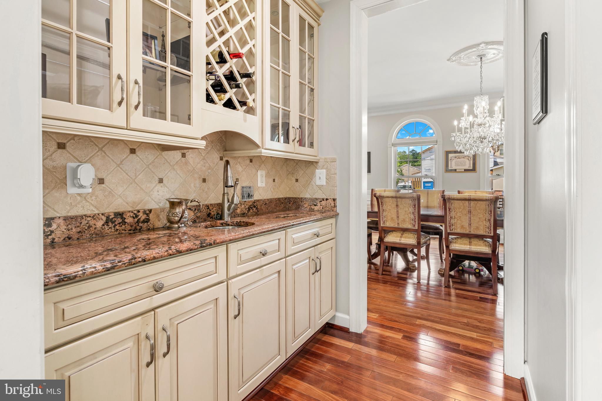 3213 Hatton Road Baltimore, MD 21208 - Photo 10 of 69 a kitchen with stainless steel appliances granite countertop a stove and white cabinets with wooden floor