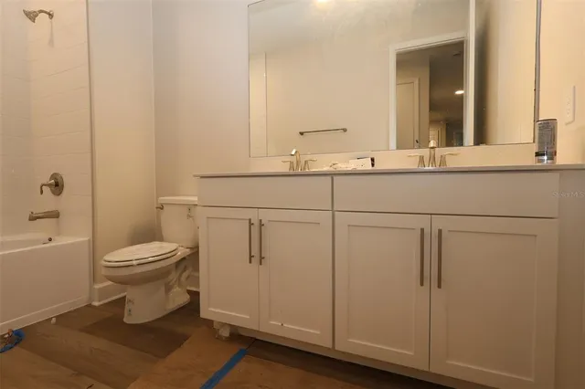 a bathroom with a toilet a sink and bathtub