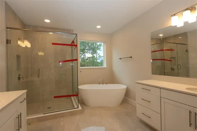 a spacious bathroom with a shower sink and mirror