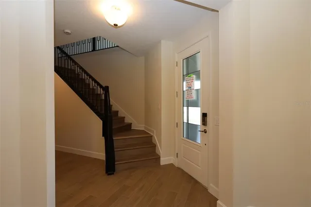 a view of entryway and hall with wooden floor