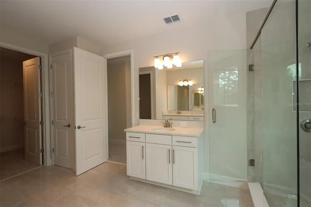 a bathroom with a double vanity sink a toilet and a mirror